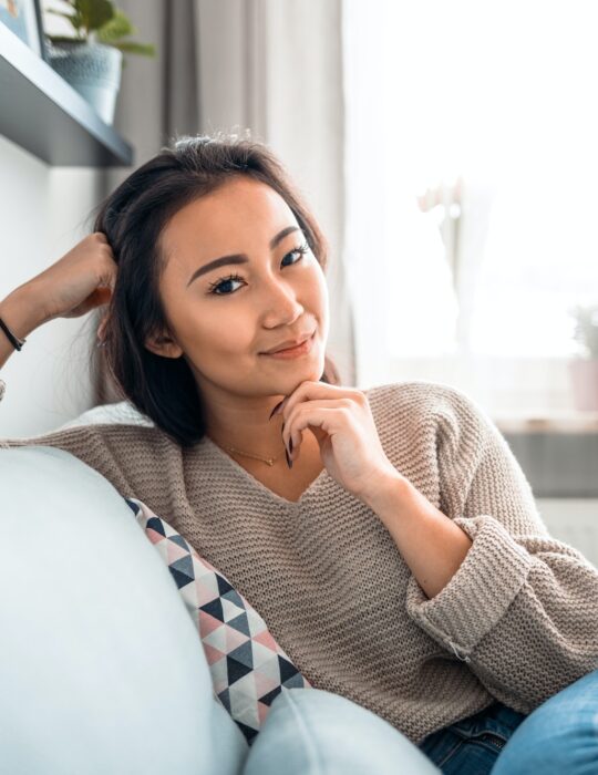 Asian girl at home deep in thoughts thinking and planning
