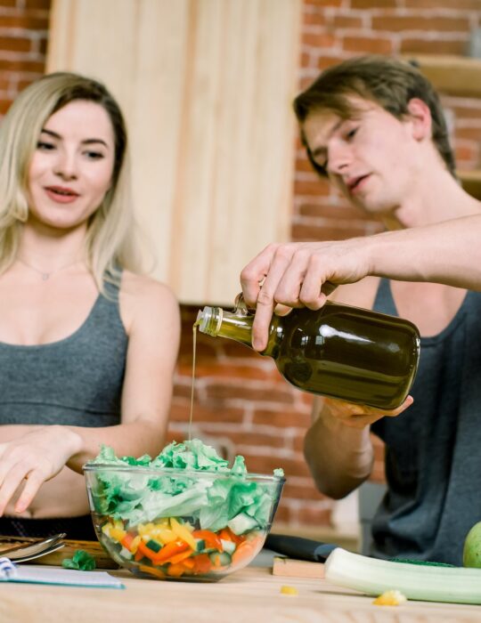 diet, healthy eating, fitness lifestyle, proper nutrition. health conscious couple cooking low